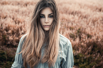 Beautiful and young girl in a man's shirt standing in the field.
shirt for the girl. Nature. Wind inflates hair. - 115459817