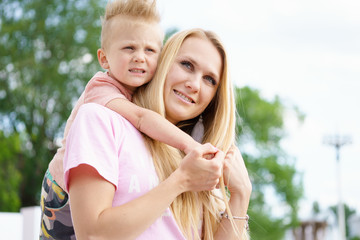 The son hugs mom at outdoor