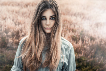 Beautiful and young girl in a man's shirt standing in the field. Fog.
shirt for the girl. Nature. Wind inflates hair. - 115459879