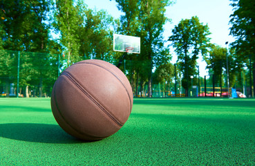 Basketball ball on green field floor