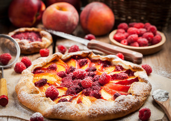 Rustic open pie with peach and raspberry