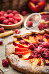 Rustic open pie with peach and raspberry