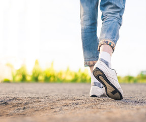 woman in white sneakers walking on a ground