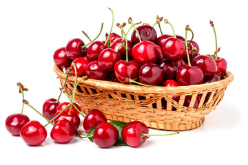 cherries in a wicker basket isolated on white background