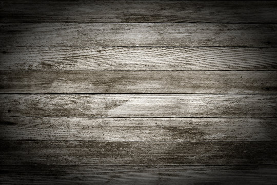 background texture of old gray wooden barn boards with vignette. black and white photo