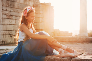 Portrait of a beauty little ballerina on sunset