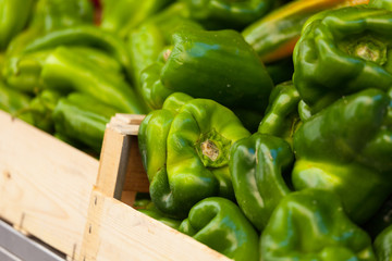 Green pepper in a wood basket at market