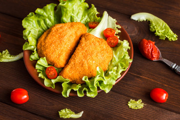 chicken cutlets with cherry tomatoes and lettuce