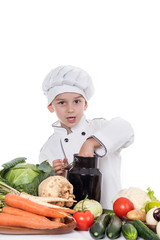 One little boy as chef cook making salad, cooking with vegetable
