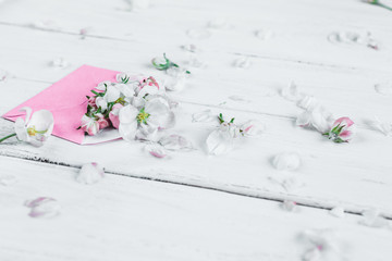 pink envelopes with flowers on white wooden background
