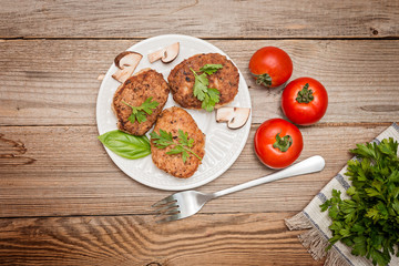 grilled pork cutlets. Fried pork burgers with tomatoes on the wooden background