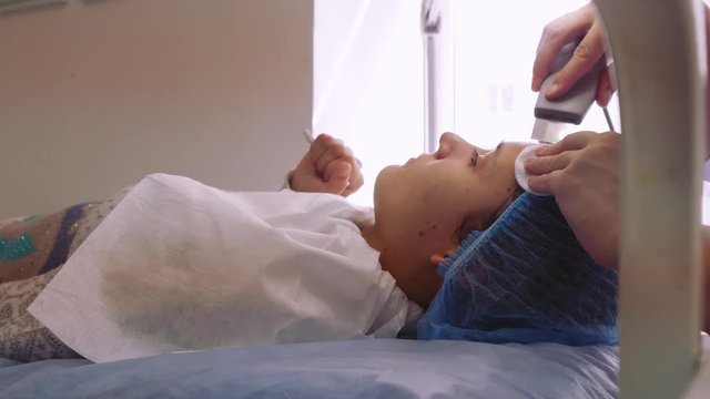 Woman receiving cleansing therapy with a professional ultrasonic equipment in cosmetology office. 1920x1080