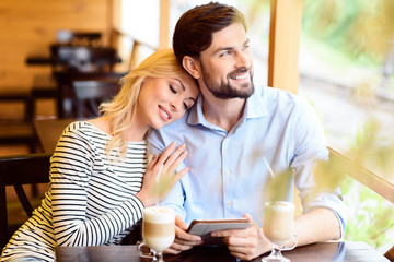 Dreamful lovers resting in cafe