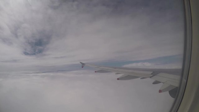 Color footage of an airplane wing while flying.