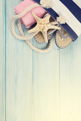 Fototapeta na wymiar Beach accessories on wooden background