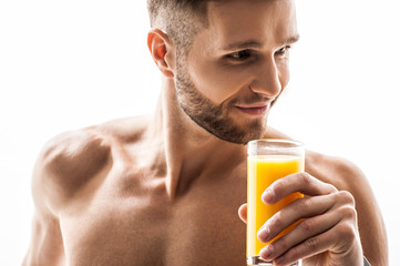 Joyful male athlete prefers healthy drink