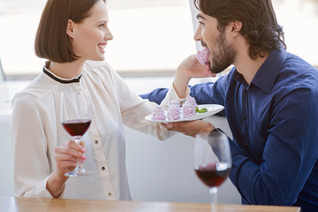 Pretty loving couple enjoying sweet food