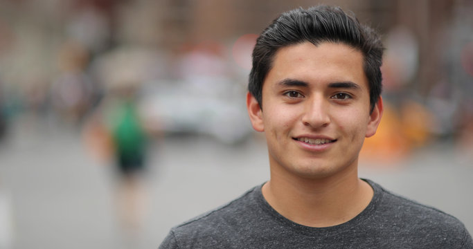 Young latino man in city face portrait smile
