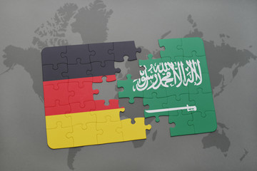 puzzle with the national flag of germany and saudi arabia on a world map background.