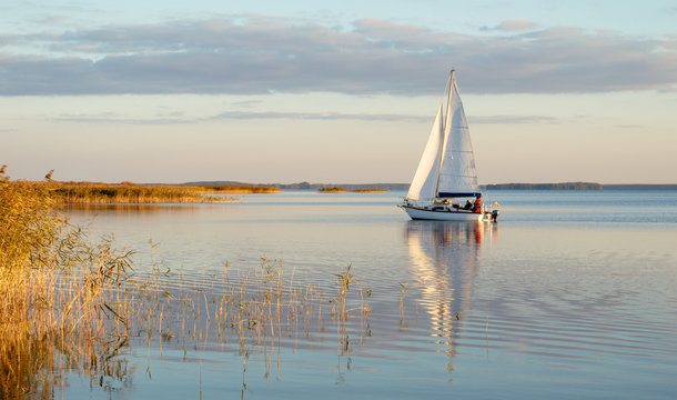 Sailing Boat On A Calm Lake With Reflection