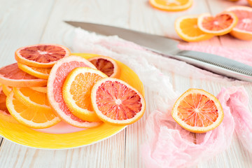 Citrus fruits and knife on wooden table. Close up