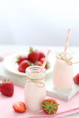 Strawberry yogurt in bottle on wooden table