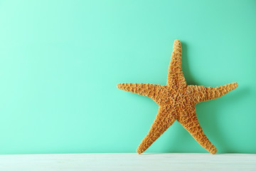 Fototapeta na wymiar Starfish on a green wooden table