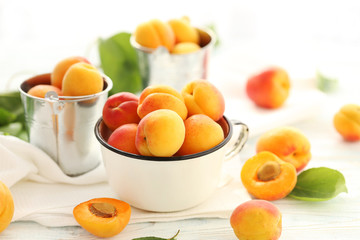 Naklejka na ściany i meble Ripe apricots fruit on white wooden table