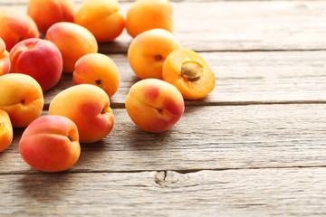 Fototapeta na wymiar Ripe apricots fruit on grey wooden table