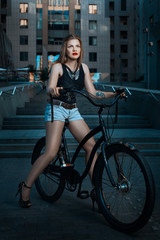 Fototapeta na wymiar Biker girl on a bicycle.