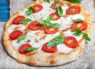 Pizza Margherita on dark wooden background