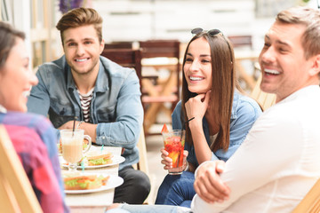 Happy friends having lunch in cafe