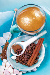 Fragrant spices, coffee, cinnamon and marshmallow on turquoise c