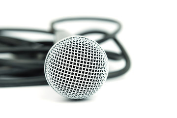 Close up photo of microphone and cable on white background