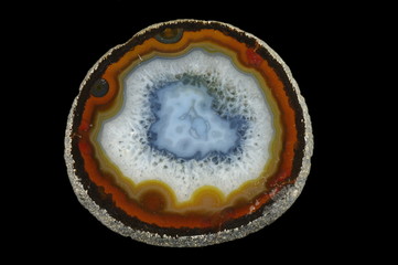 A cross section of the agate stone on the black background. Origin: Brazil.