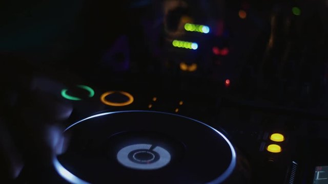Dj in headphones spinning at turntable on party in nightclub. Disk. Rotating. Cheering