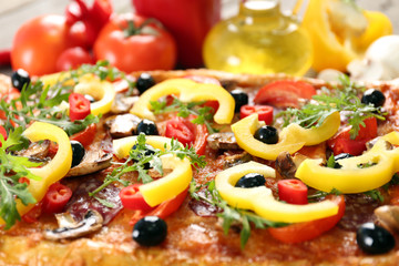 Rectangle delicious pizza and vegetables on the table, close-up