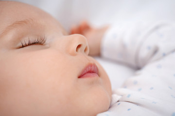 Beautiful sleeping baby in bed