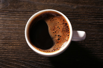 Cup of fresh coffee on wooden background