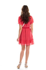 Girl wears red dress. Back view of young woman. Pretty model on white background. What a charming look.
