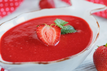 A bowl of strawberry soup gazpacho with mint