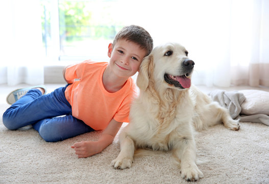 Small boy and cute dog at home