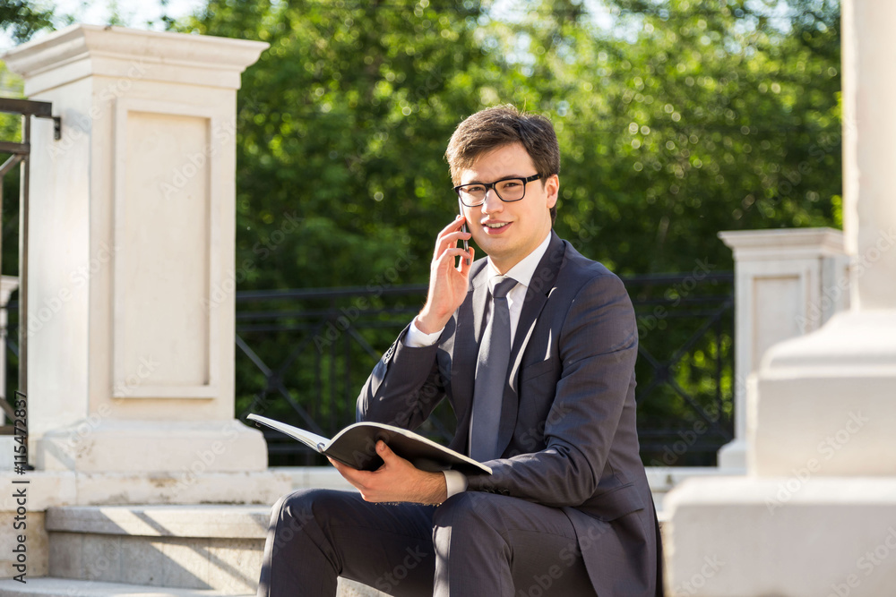 Sticker Businessman on phone holding notepad