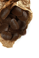 Chocolate chips in parchment on white background