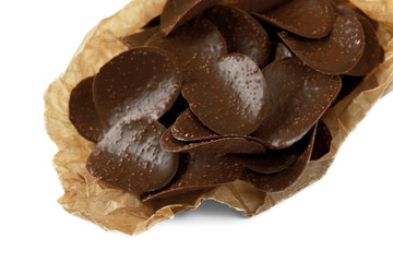 Chocolate chips in parchment on white background