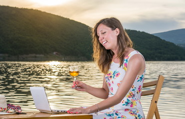 Woman having a video call by the lake