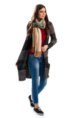 Woman in dark sweater coat. Black shoes and blue jeans. Woolen garment of high quality. Warm and comfortable clothes.