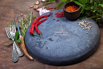 Herbs and spices in wooden background, close up