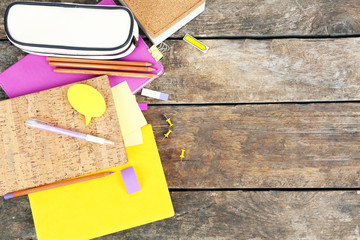 School supplies on old wooden table, close up