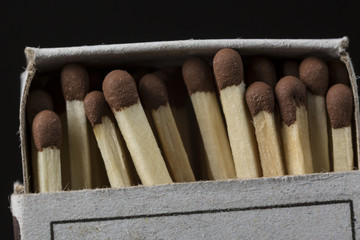 Matches in a box close up on black
